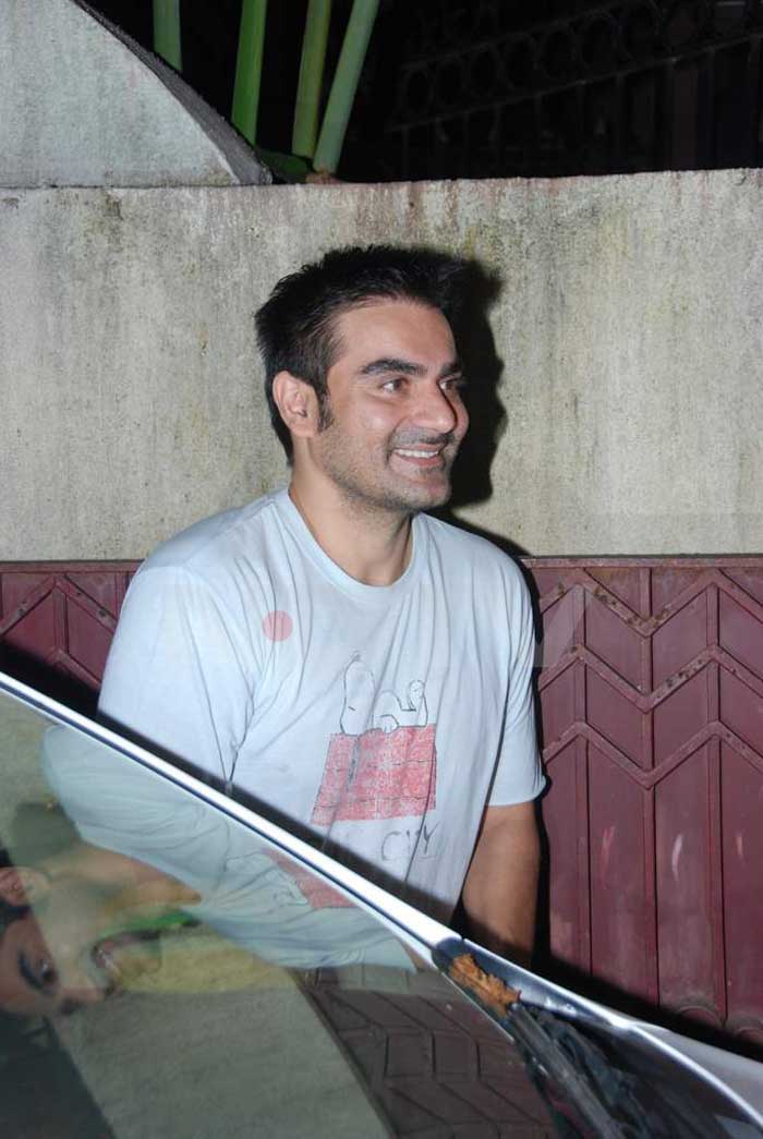 Arbaaz Khan smiles for the cameras as he gets out of his car.