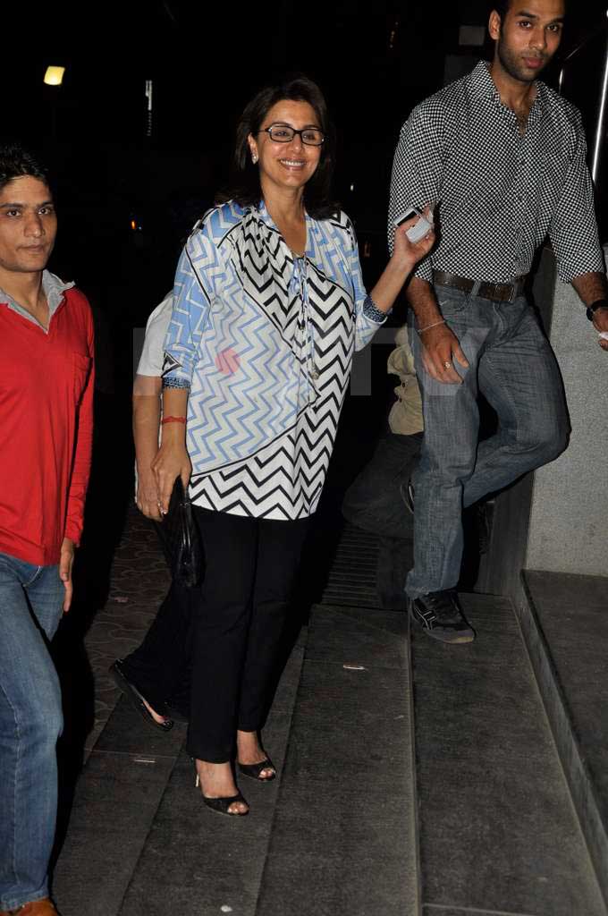 Neetu Singh, here to watch son Ranbir Kapoor's latest movie, flashes a radiant smile for the cameras.