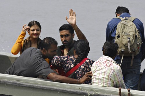 Aishwarya and Abhishek gesture to fans as they head out on a boat for filming on the Ganga river at Agarpara, near Kolkata. Abhishek is playing the central character in Mani Ratnam's movie <i>Raavan</i>, a modern adaptation of the epic Ramayana.