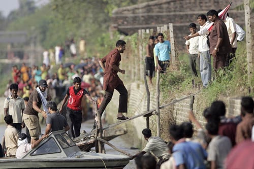 Abhishek Bachchan runs up a gangway plank.