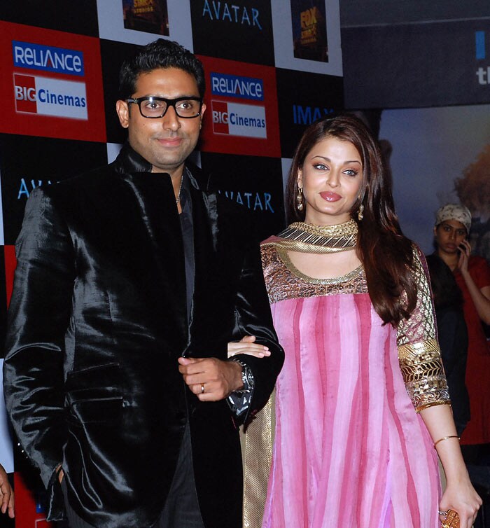 Actor Abhishek Bachchan (L) and his wife Aishwrya Rai Bachchan smile during the Indian premiere of the film <i>Avatar</i> in Mumbai. (Photo: AFP)