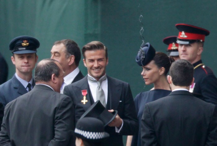 David Beckham wears his OBE medal with his morning dress. (Photo: AP)