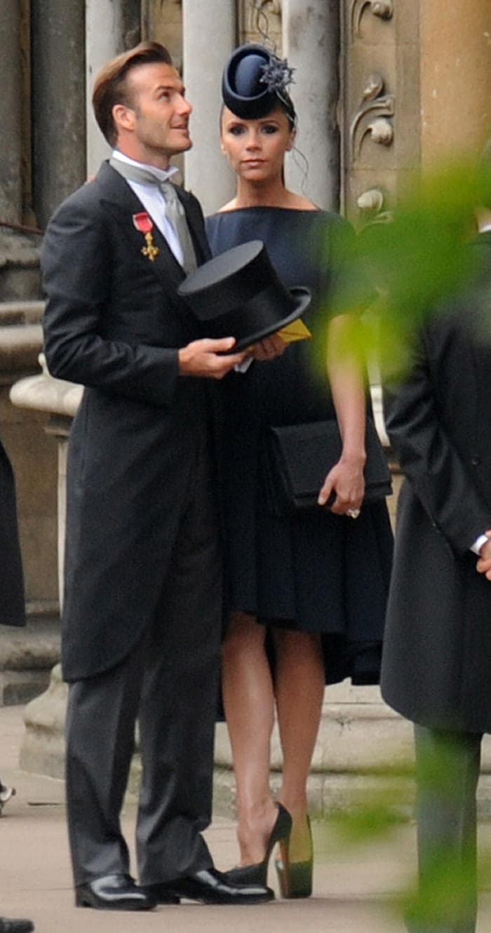 Victoria Beckham wears a dress of her own design, shoes by Louboutin, and a hat by Philip Treacy. (Photo: AP)