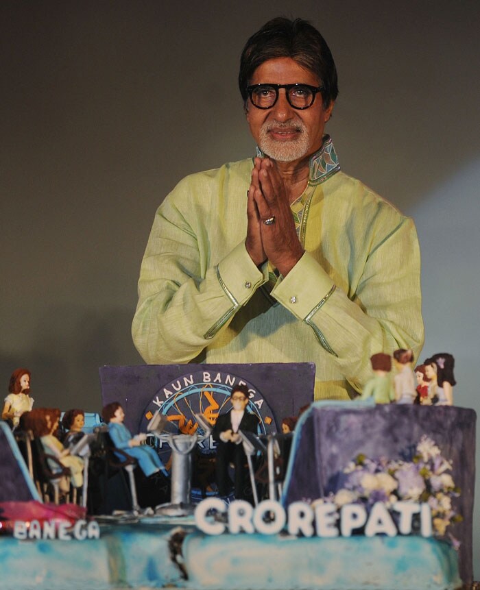 Basking in the National Award glory for his unconventional role in Paa, megastar Amitabh Bachchan, who turned 68 today, is still going strong and continues to be the busiest actor of his generation in the Hindi film industry. <BR><BR>Amitabh Bachchan gestures as he poses with a cake during a function to promote his show <I>Kaun Banega Crorepati</I>. (Photo: AFP)