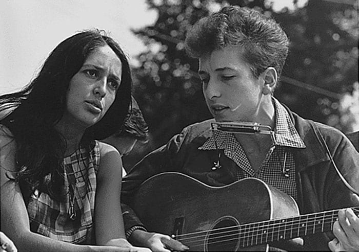 Dylan had a number of influences in his career. Apart from mentors like Woody Guthrie and Jack Elliott, Dylan was pushed to success by fellow singer Joan Baez, who invited him to sing on her shows. The two were romantically involved and did many protest songs together. Baez, who is more of an interpretative singer, has done extremely popular versions of Dylan's songs like <i>Farewell</i>, <i>Angelina</i> and <i>It Ain't Me Babe</i>.