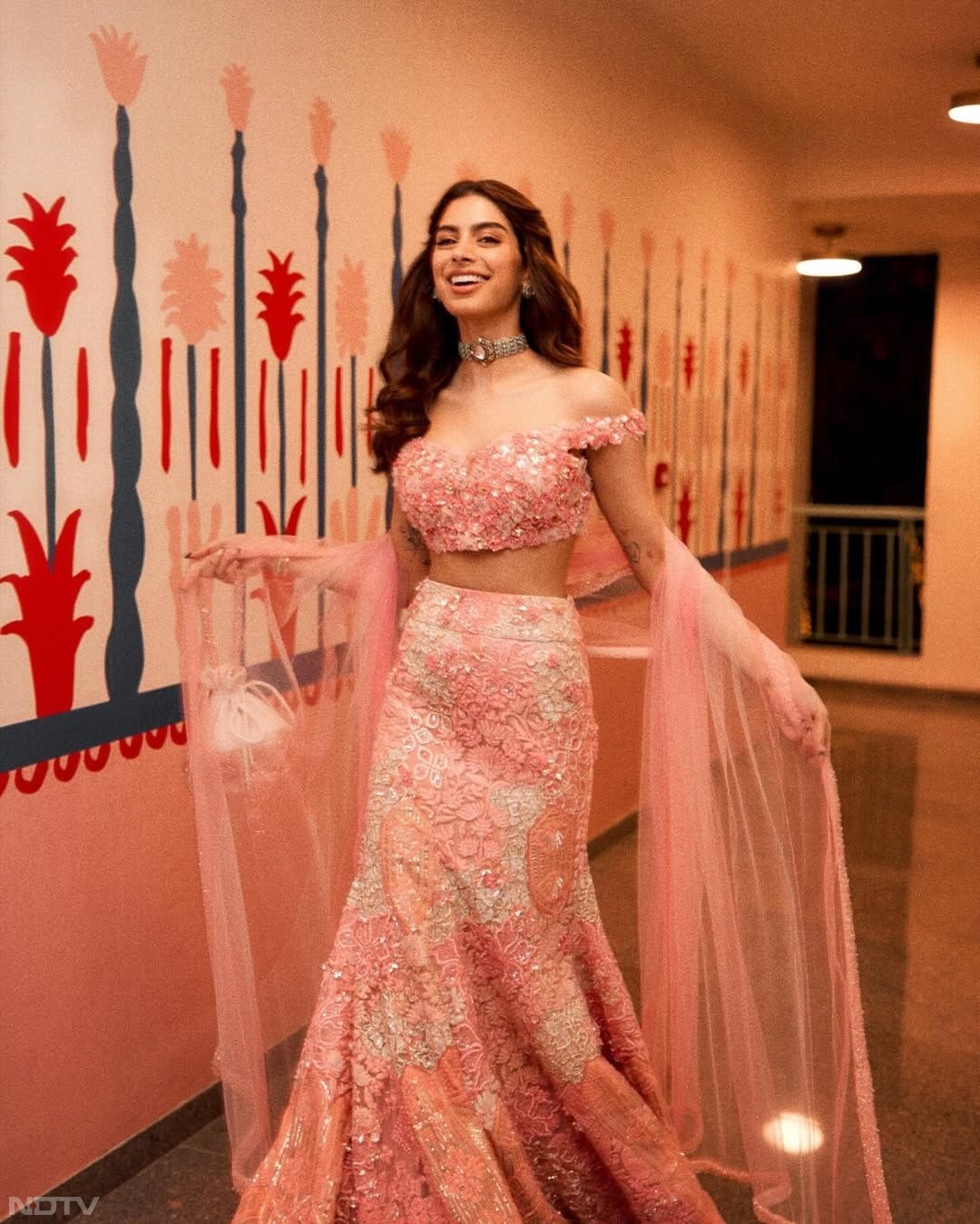 Khushi Kapoor turned heads in a blush pink floral bodycon lehenga paired with an off-shoulder blouse, effortlessly exuding charm for an adorable and eye-catching look. (Instagram/@khushikapoor)