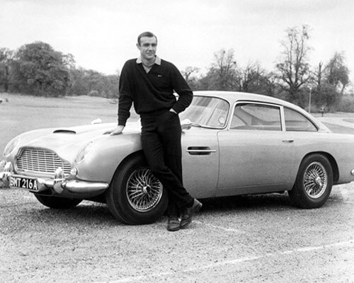 <B>Bond's best</b>: One of the coolest gadgets (if you can call a car that) was, and continues to be the Aston Martin which is Bond's signature car for all practical purposes. In this picture, Sean Connery next to an Aston Martin DB5 in the film <I>Goldfinger</i> (1964).