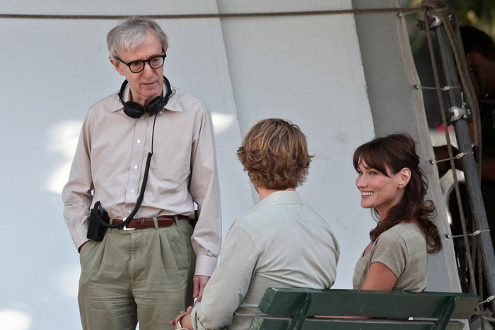 Carla Bruni-Sarkozy listened to Woody Allen and jotted points while seated next to actor Owen Wilson on a park bench.