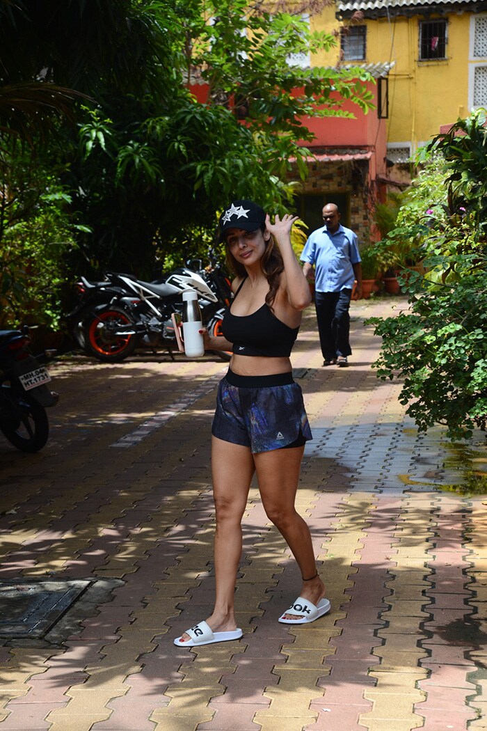 Malaika Arora waved to the shutterbugs outside a yoga studio.