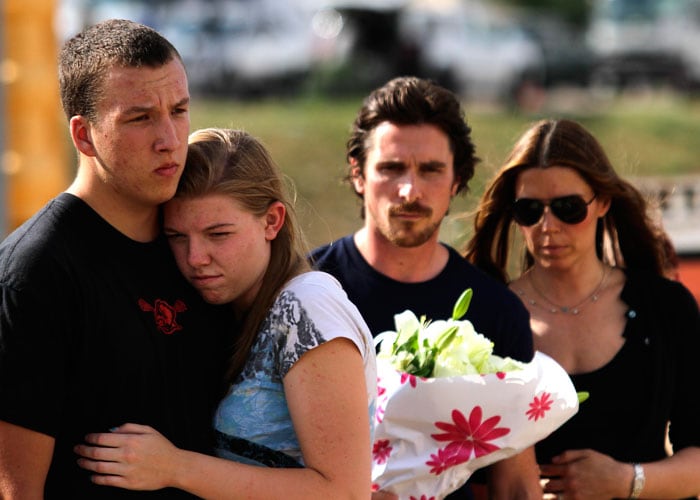 Christian Bale and his wife Sibi join other mourners at the memorial.