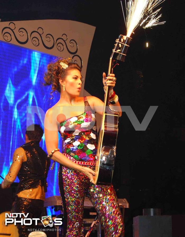 Sri Lankan beauty queen-turned-actress, Jacqueline Fernandez, dances to rock tunes with a guitar. We wonder why she chose this bright multi-coloured outfit.