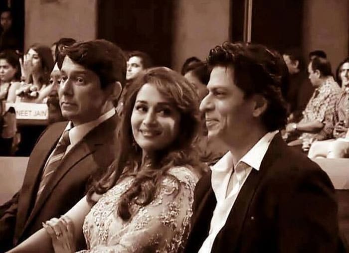 Bollywood actress Madhuri Dixit looks only too pleased to be sandwiched between husband Sriram Nene and her <i>Dil Toh Pagal Hai</i> and <i>Devdas</i> co-star Shah Rukh Khan at an award function. While Mr Nene seems engrossed in the proceedings, Madhuri and SRK clearly have some mischief up their sleeves.<br><br>

This picture was posted on Twitter by <a href="https://twitter.com/SRKFC1" rel="nofollow">@SRKFC1</a>
<br><br>

Coming up: Arshad's <i>Ishqiya</i> with Madhuri, Huma