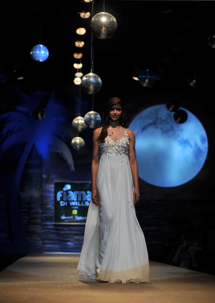 The former model also walked the ramp at the Wills Lifestyle India Fashion Week Spring-Summer 2012. She wore a moonlight white bridal beach gown scattered with rose petal confetti and swirling butterflies.