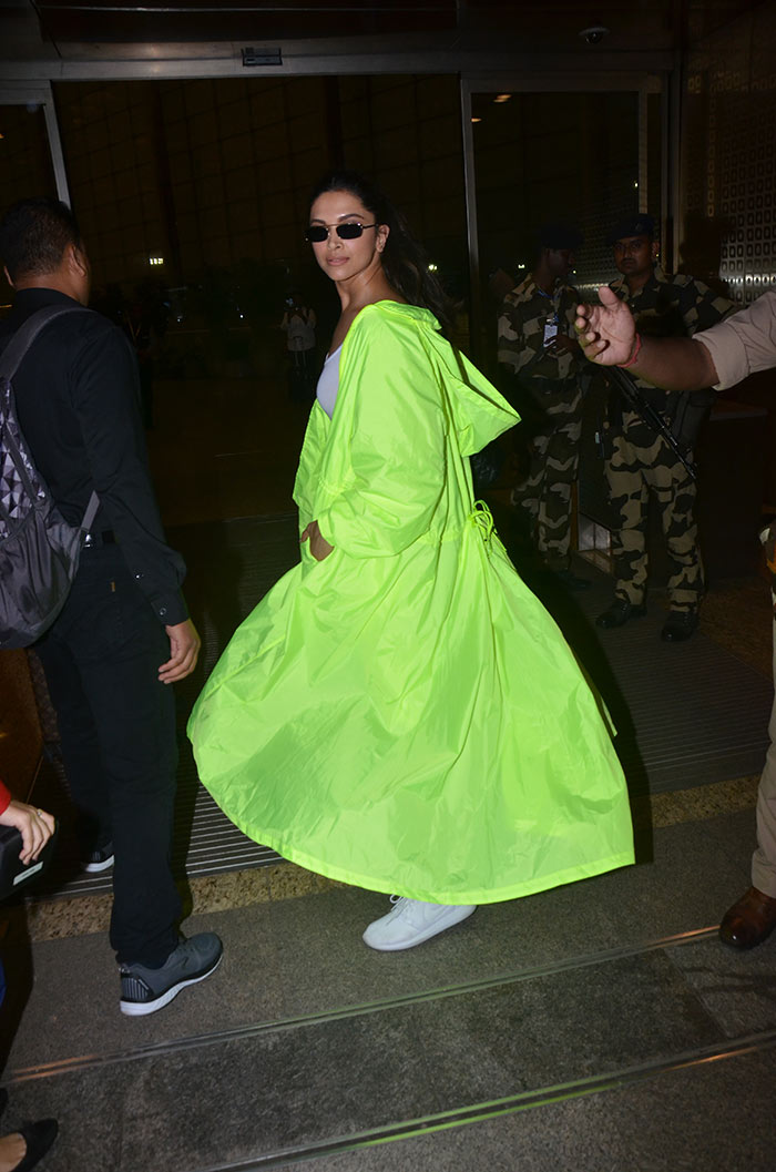 Deepika Padukone flaunts a neon green sling bag on her return from New York
