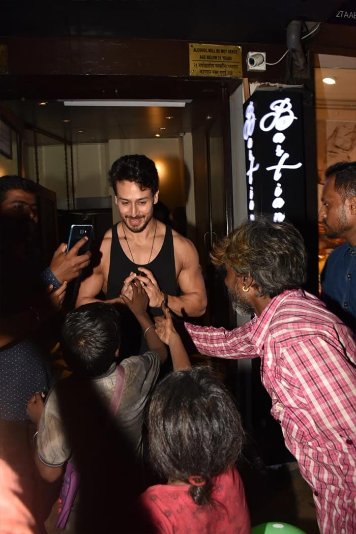 Tiger Shroff smiled as he met the crowd outside the eatery.