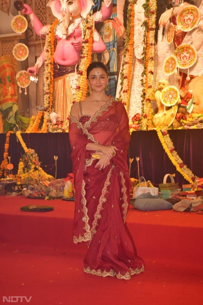 Alia Bhatt wore a sheer red saree for the puja. (Image Courtesy: Varinder Chawla)