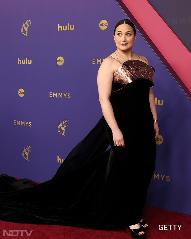 Lily Gladstone walked the red carpet wearing a Rodarte black velvet gown with a copper chest plate. She was a presenter as well as a nominee for Best Supporting Actress in a limited series for <i>Under The Bridge</i>. (Image Courtesy: Getty)