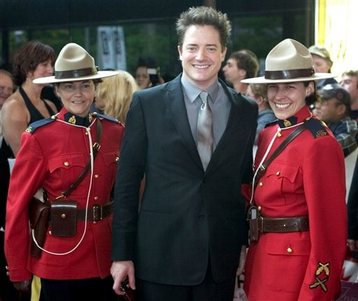 Brendan Fraser poses with members of the RCMP as he arrives for induction ceremonies at the Canadian Walk of Fame in Toronto.