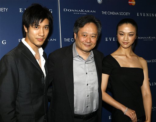 Actor Wang Lee Hom, left, and actress Tang Wei, right, pose with director Ang Lee as they arrive at the premiere of Evening.