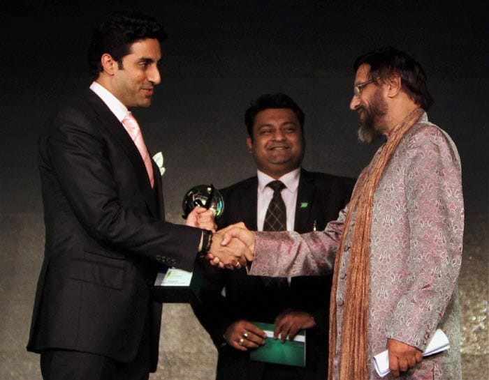 The Energy and Resources Institute (TERI) Director General R.K. Pachauri presents the Green Globe for outstanding efforts in fighting climate changes by a celebrity Award to Bollywood actor Abhishek Bachchan during a ceremony in New Delhi on Thursday (February 2).