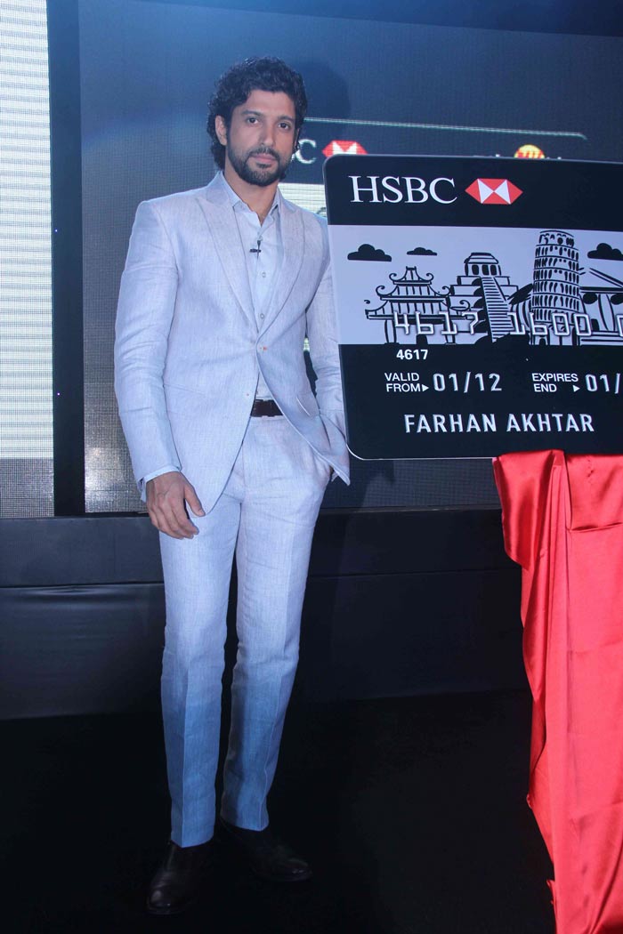 Farhan Akhtar poses for shutterbugs with the oversized credit card.