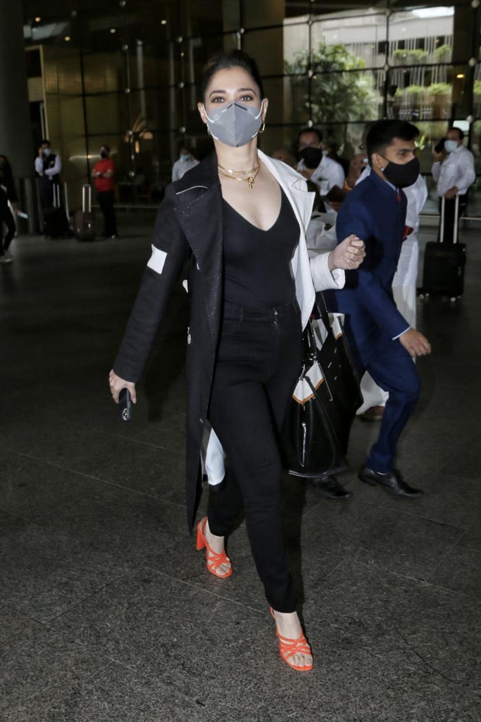 Tamannaah Bhatia added a pop of colour to her monochrome look with neon orange shoes.