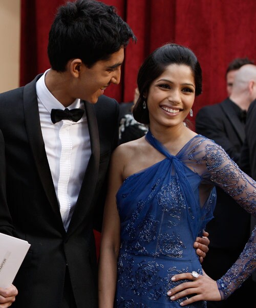 Frieda Pinto stands with <I>Slumdog Millionaire</i> star Dev Patel. Rumours of a romantic relationship between the two are ablaze.