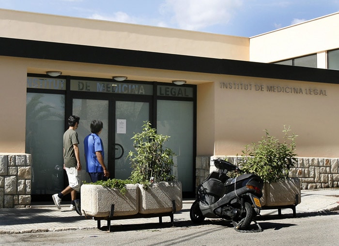 Two people walk past the morgue where Boyzone lead singer Stephen Gately's body rests on October 11, 2009. Although foul play and suicide have virtually been ruled out, a postmortem will be conducted later this week to determine exact cause of death. Gately's family hopes to have the body returned  soon for the funeral in Dublin. (Photo: AFP)