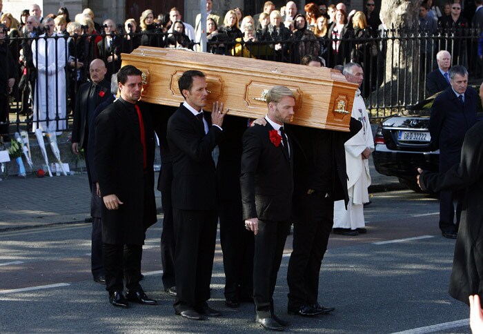 The coffin carrying the body of Stephen Gately, the Irish singer from pop group Boyzone is carried by Mickey Graham (L) Undentified (C), and Shane Lynch (R) from St Laurence O'Toole's Church in Dublin, on October 17, 2009. An autopsy on Stephen Gately revealed that he died due to excess fluid in his lungs, a court spokeswoman on the Spanish island of Majorca said on October 13. Gately, 33, was found dead on October 10 in his apartment in the Majorcan town of Port Andratx while on holiday on the Mediterranean island. News reports said he had been out late the night before. Gately, who married his partner Andrew Cowles in a civil union in 2006, sent ripples through the pop music world 10 years ago when he announced that he was gay. (Photo: AFP)