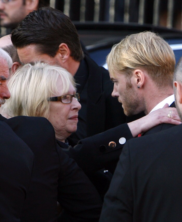Margaret Gatley (L) embraces Ronan Keating (R), outside St Laurence O'Toole's Church in Dublin, on October 17, 2009. An autopsy on Stephen Gately revealed that he died due to excess fluid in his lungs, a court spokeswoman on the Spanish island of Majorca said on October 13. Gately, 33, was found dead on October 10 in his apartment in the Majorcan town of Port Andratx while on holiday on the Mediterranean island. News reports said he had been out late the night before. Gately, who married his partner Andrew Cowles in a civil union in 2006, sent ripples through the pop music world 10 years ago when he announced that he was gay. (Photo: AFP)