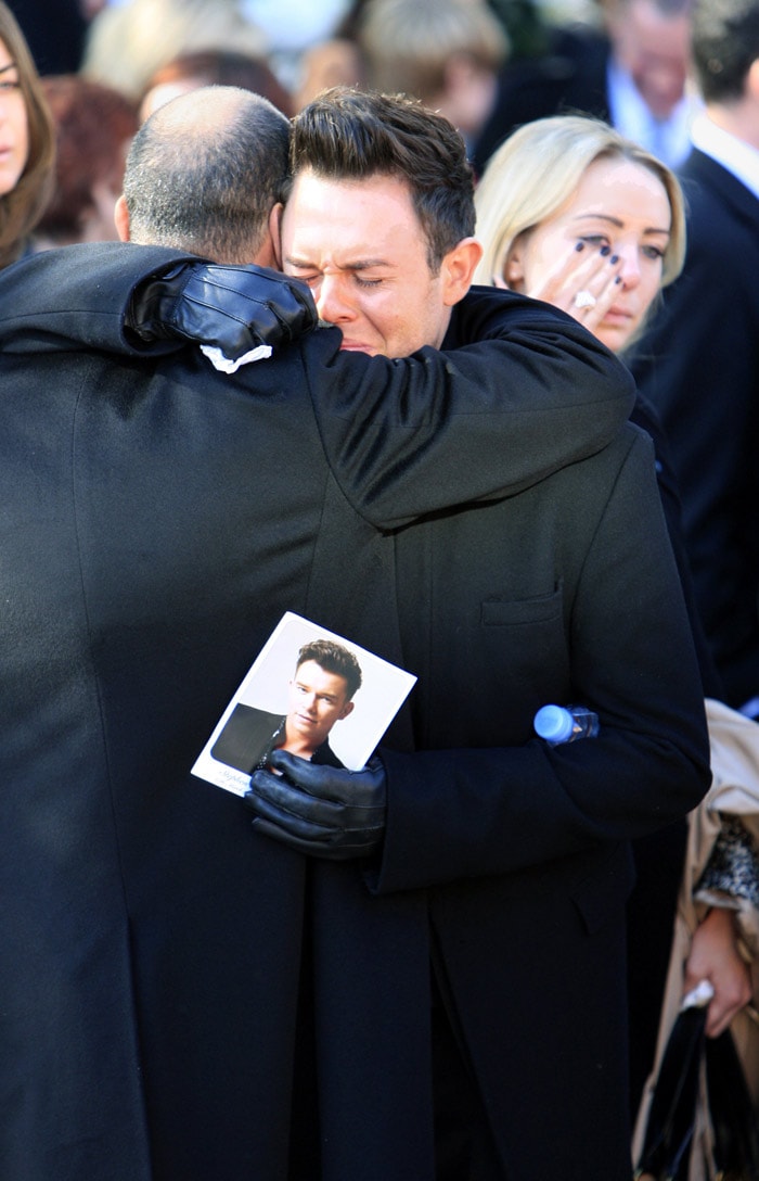 A mourneris pictured outside the funeral of Stephen Gately, the Irish singer from pop group Boyzone at St Laurence O'Toole's Church in Dublin, on October 17, 2009. An autopsy on Stephen Gately revealed that he died due to excess fluid in his lungs, a court spokeswoman on the Spanish island of Majorca said on October 13. Gately, 33, was found dead on October 10 in his apartment in the Majorcan town of Port Andratx while on holiday on the Mediterranean island. News reports said he had been out late the night before. Gately, who married his partner Andrew Cowles in a civil union in 2006, sent ripples through the pop music world 10 years ago when he announced that he was gay. (Photo: AFP)