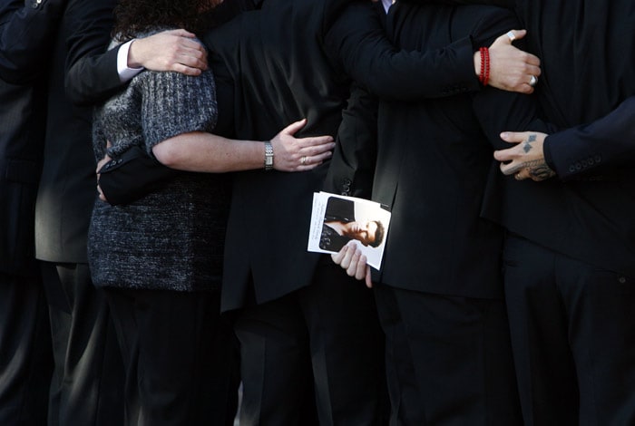 A photograph of Stephen Gately is carried by members of Boyzone and family as the coffin carring the body of Stephen Gately, the Irish singer from pop group Boyzone is carried from St Laurence O'Toole's Church in Dublin, on October 17, 2009. An autopsy on Stephen Gately revealed that he died due to excess fluid in his lungs, a court spokeswoman on the Spanish island of Majorca said on October 13. Gately, 33, was found dead on October 10 in his apartment in the Majorcan town of Port Andratx while on holiday on the Mediterranean island. News reports said he had been out late the night before. Gately, who married his partner Andrew Cowles in a civil union in 2006, sent ripples through the pop music world 10 years ago when he announced that he was gay. (Photo: AFP)