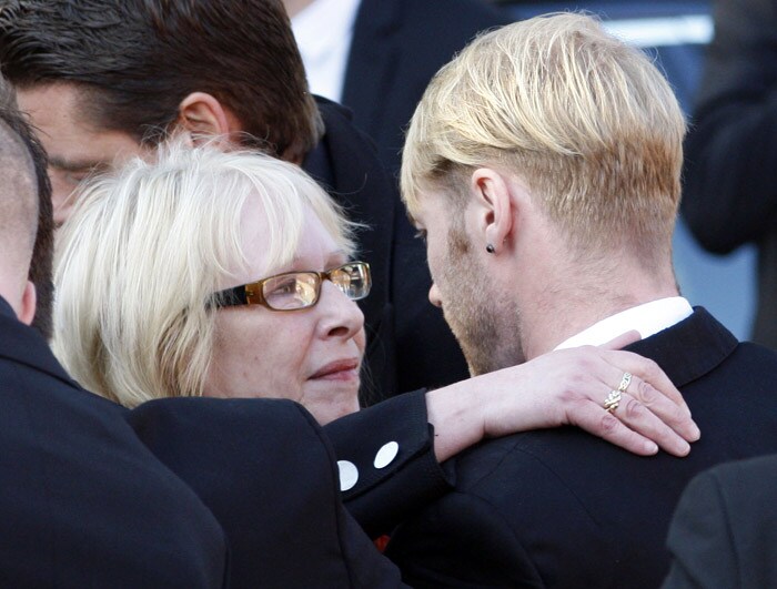 Margaret Gately mother of Stephen Gately is comforted by Ronan Keating of Irish band Boyzone at St. Laurence O'Toole Church, after the funeral service, in Dublin, Ireland, Saturday Oct. 17, 2009. Gately was found dead on Saturday, Oct. 10, 2009, in a house near Port d'Andratx on the western tip of Mallorca. The singer had gone to Mallorca with his partner Andrew Cowles. The two were wed in a civil union in 2006. Autopsy results released on Tuesday showed Gately died of natural causes. Photo of Gately seen on the right. (Photo: AP)