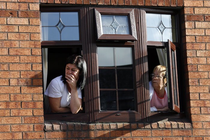 Residents watch the funeral of Stephen Gately of Irish band Boyzone, during the funeral at St. Laurence O'Toole Church, in Dublin, Ireland, Saturday Oct. 17, 2009. Gately was found dead on Saturday, Oct. 10, 2009, in a house near Port d'Andratx on the western tip of Mallorca. The singer had gone to Mallorca with his partner Andrew Cowles. The two were wed in a civil union in 2006. Autopsy results released on Tuesday showed Gately died of natural causes.. (Photo: AP)