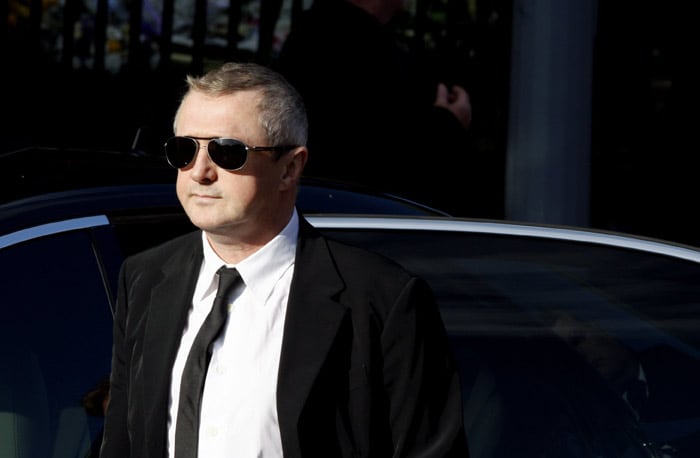 Louis Walsh arrives for the funeral of Stepehn Gately from Irish band Boyzone, at St. Laurence O'Toole Church,  in Dublin, Ireland, Saturday Oct. 17, 2009. Gately was found dead on Saturday, Oct. 10, 2009, in a house near Port d'Andratx on the western tip of Mallorca. The singer had gone to Mallorca with his partner Andrew Cowles. The two were wed in a civil union in 2006. Autopsy results released on Tuesday showed Gately died of natural causes. Photo of Gately seen on the right. (Photo: AP)