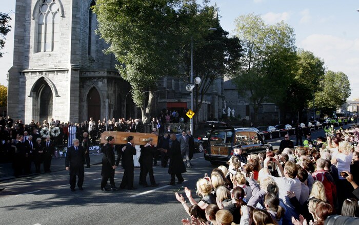 Members of Irish band Boyzone, carry the coffin of Stephen Gately from St. Laurence O'Toole Church, after the funeral service, in Dublin, Ireland, Saturday Oct. 17, 2009. Gately was found dead on Saturday, Oct. 10, 2009, in a house near Port d'Andratx on the western tip of Mallorca. The singer had gone to Mallorca with his partner Andrew Cowles. The two were wed in a civil union in 2006. Autopsy results released on Tuesday showed Gately died of natural causes. Photo of Gately seen on the right. (Photo: AP)