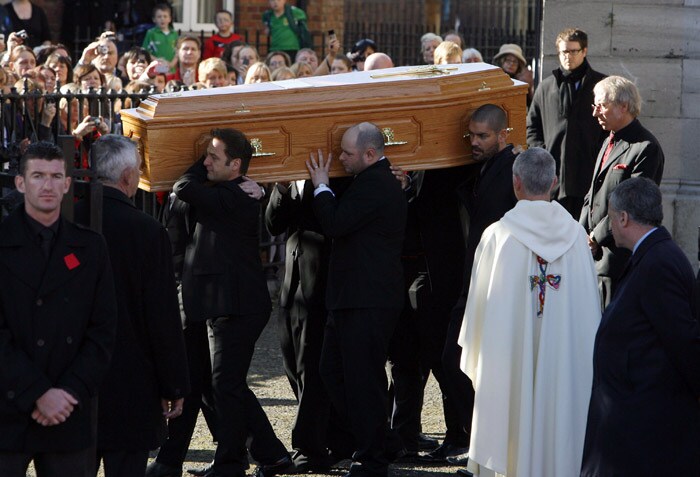 The coffin carrying the body of Stephen Gately, the Irish singer from pop group Boyzone is carried by Mickey Graham (L) Undentified (C), and Shane Lynch (R) from St Laurence O'Toole's Church in Dublin, on October 17, 2009. An autopsy on Stephen Gately revealed that he died due to excess fluid in his lungs, a court spokeswoman on the Spanish island of Majorca said on October 13. Gately, 33, was found dead on October 10 in his apartment in the Majorcan town of Port Andratx while on holiday on the Mediterranean island. News reports said he had been out late the night before. Gately, who married his partner Andrew Cowles in a civil union in 2006, sent ripples through the pop music world 10 years ago when he announced that he was gay. (Photo: AFP)