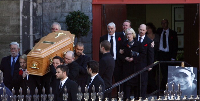 The coffin carrying the body of Stephen Gately, the Irish singer from pop group Boyzone is carried by Mickey Graham (L) Undentified (C), and Shane Lynch (R) from St Laurence O'Toole's Church in Dublin, on October 17, 2009. An autopsy on Stephen Gately revealed that he died due to excess fluid in his lungs, a court spokeswoman on the Spanish island of Majorca said on October 13. Gately, 33, was found dead on October 10 in his apartment in the Majorcan town of Port Andratx while on holiday on the Mediterranean island. News reports said he had been out late the night before. Gately, who married his partner Andrew Cowles in a civil union in 2006, sent ripples through the pop music world 10 years ago when he announced that he was gay. (Photo: AFP)