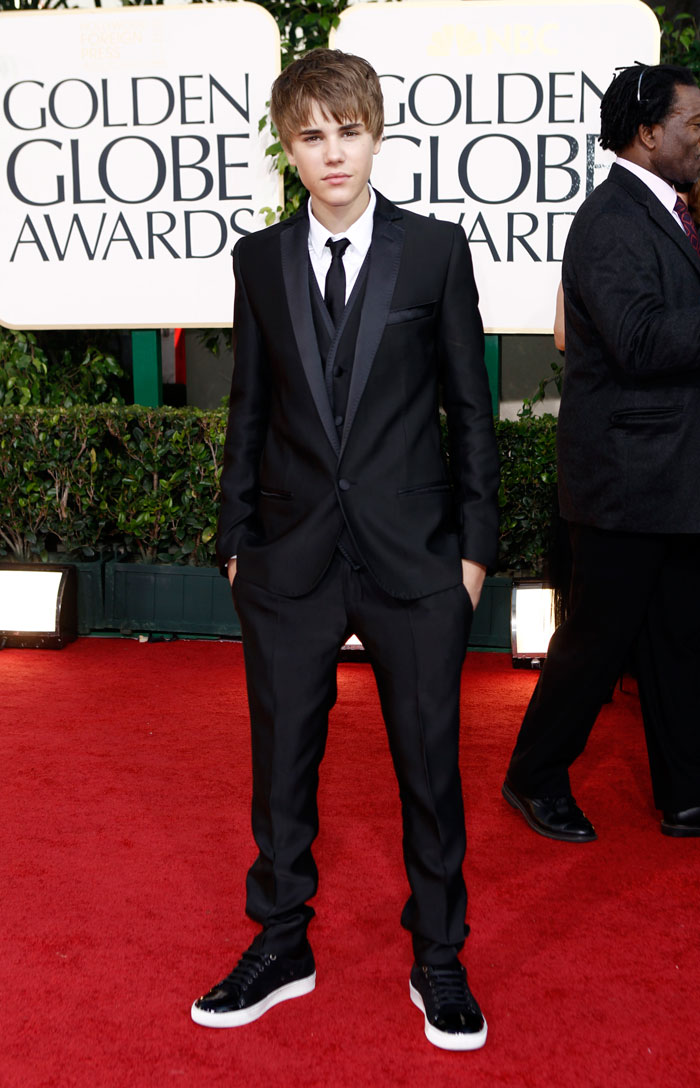 Justin Bieber poses on the red carpet wearing a D&G tuxedo.