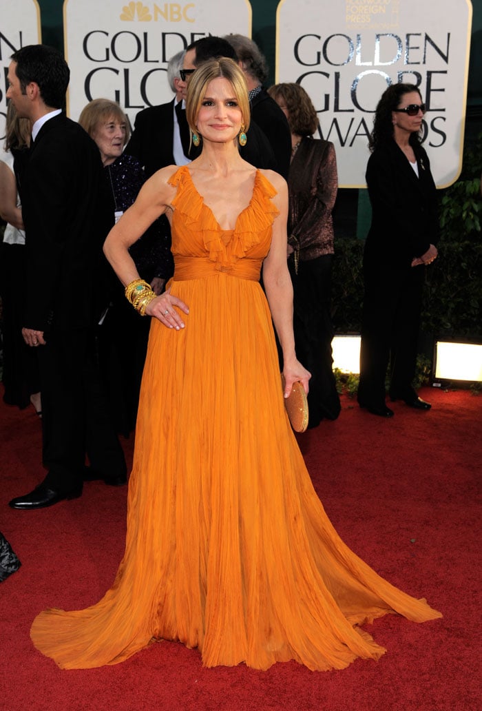 Kyra Sedgwick opts for an orange Emilio Pucci gown for the Golden Globes.