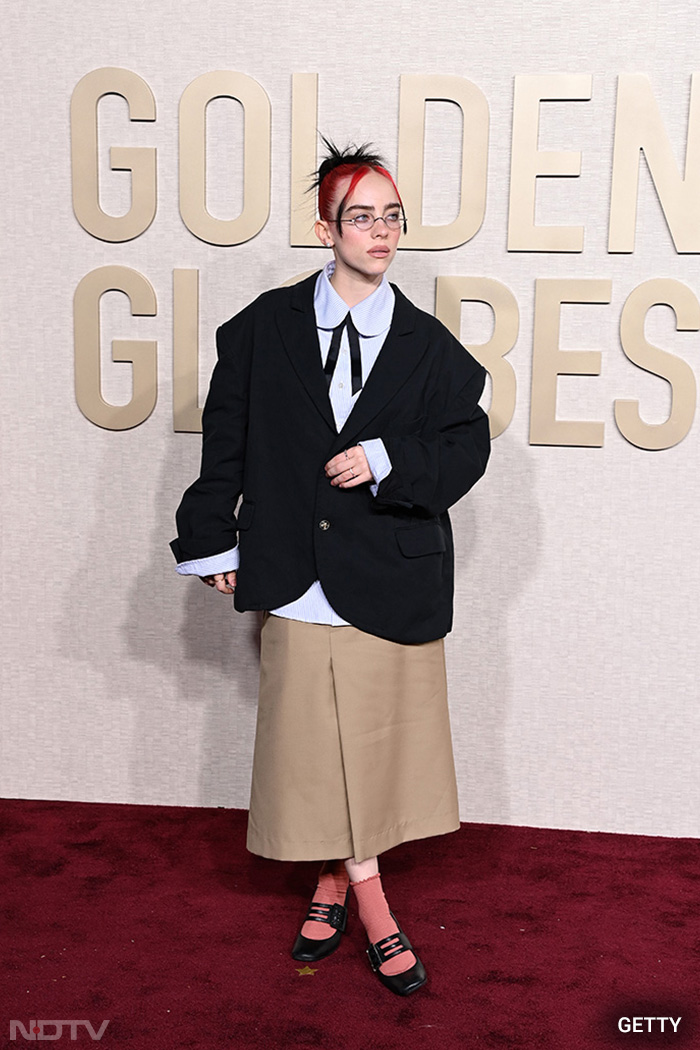 American pop star Billie Eilish attended the award show in a boxy black blazer with a red cape. (Image Courtesy: Getty Images)