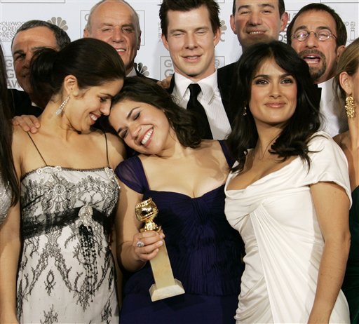 America Ferrera poses with producer Salma Hayek, right, and cast and crew after she won the award for best actress in a musical or comedy series for her work on Ugly Betty, at the 64th Annual Golden Globe Awards.