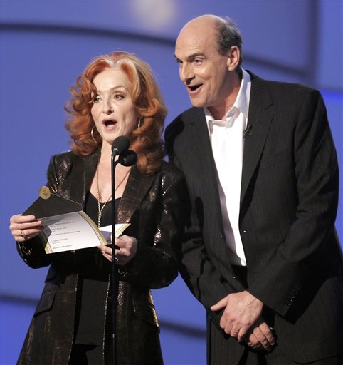 Singers Bonnie Raitt and James Taylor make an award presentation for Album of the Year at the 48th Annual Grammy Awards.