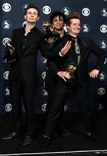 The group Green Day, Mike Dirnt, left, Billie Joe Amerstrong and Tre Cool, right, poses with their award for record of the year for Boulevard of Broken Dreams, a track from the album American Idiot, at the 48th Annual Grammy Awards.