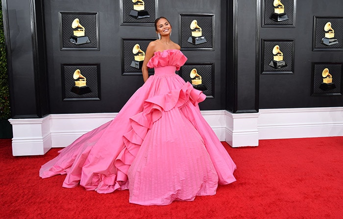 Chrissy Teigen wore an off-shoulder pink gown from Nicole and Felicia Couture