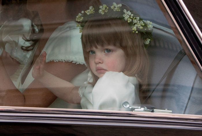 Bridesmaid Eliza Lopes, aged 3,the granddaughter of the Duchess of Cornwall, waves at the crowd. (Photo: AP)