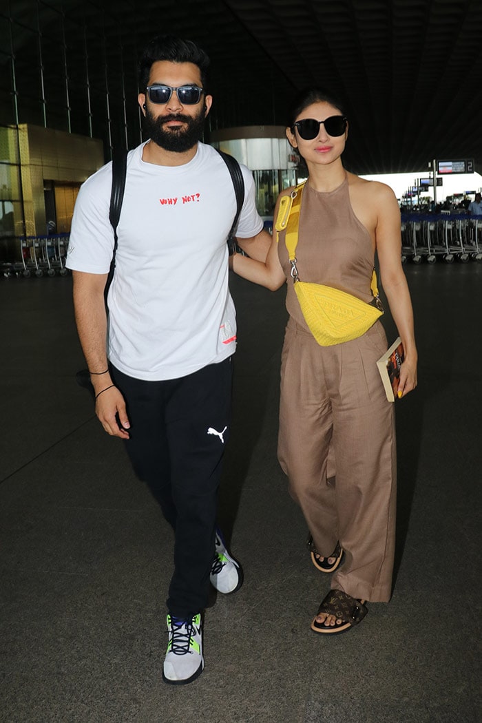 <i>Brahmastra</i> actress Mouni Roy and her husband, Suraj Nambiar, were snapped at the airport.