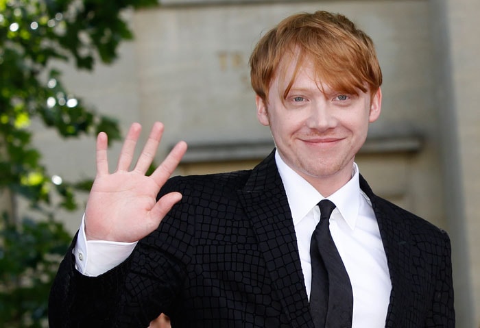 Rupert Grint waves at the crowd.