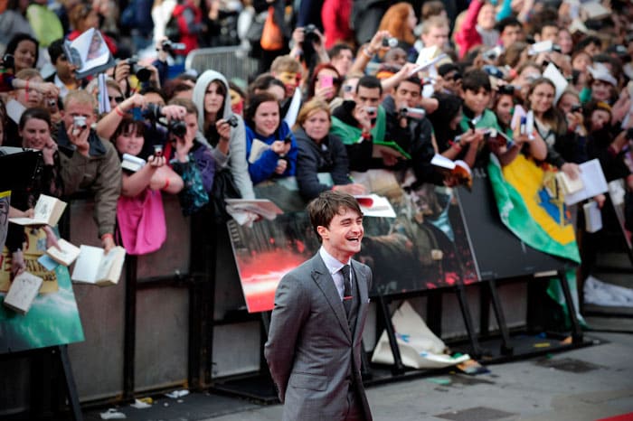 Daniel Radcliffe laughs as he gets clicked.