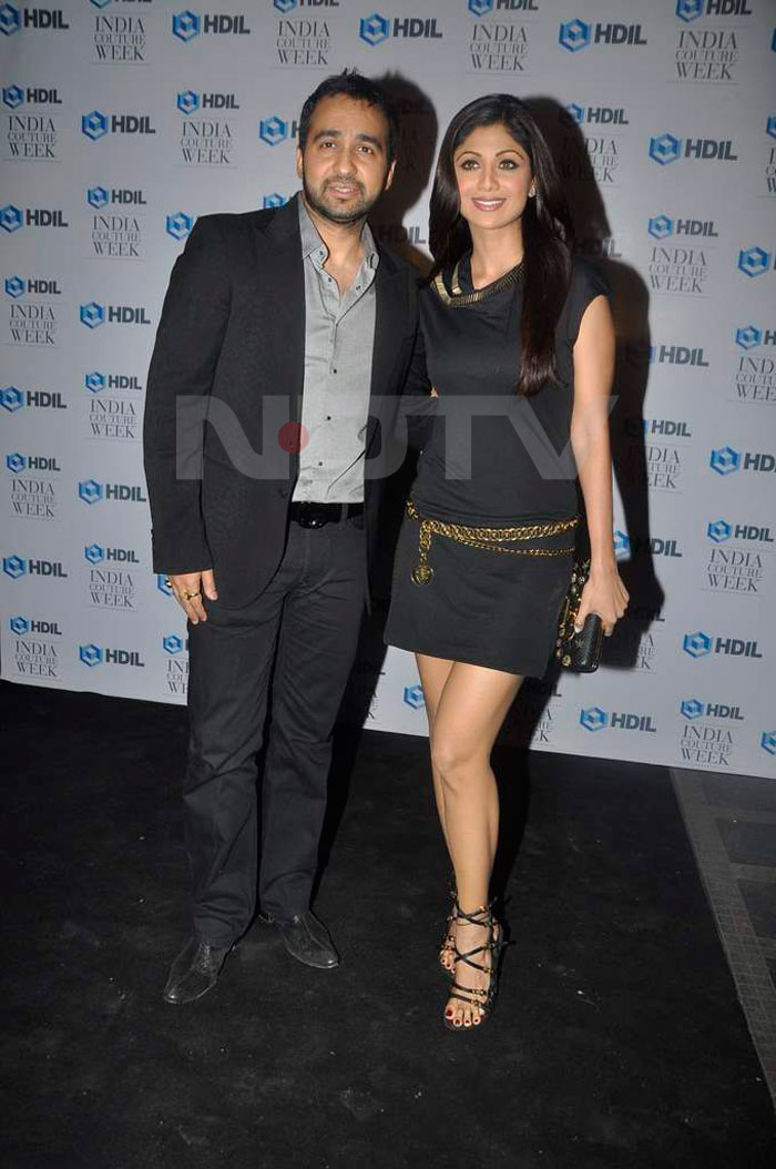 Shilpa Shetty and Raj Kundra smile for the camera.